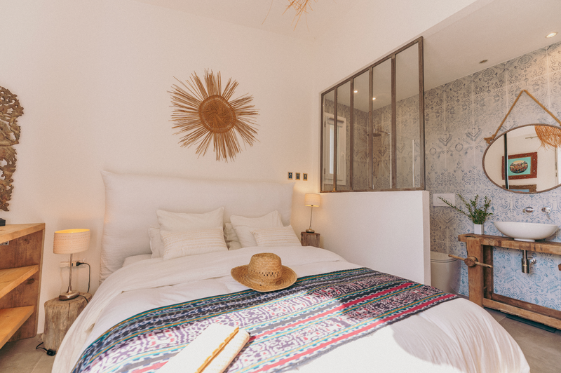 Bedroom with a bed, lamp, and decorative elements.