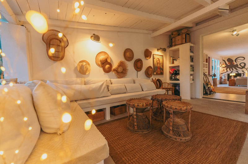 Cozy living room with wicker furniture and decorative wall art.