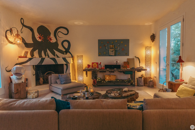 Living room with beige sofas, a fireplace, and decorative items.