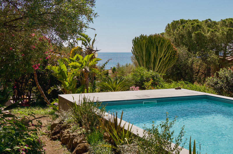 Pool area with garden and ocean view
