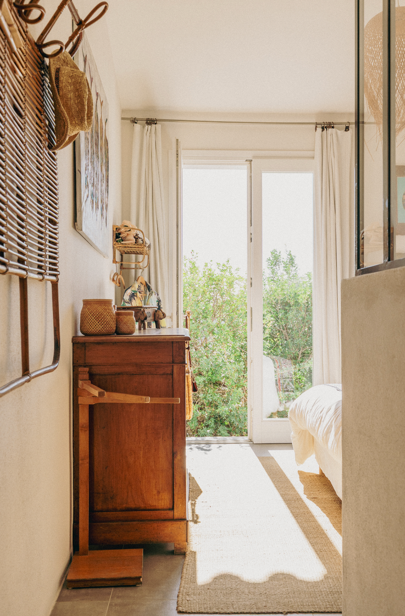 Nautical-themed room with wooden cabinet, lanterns, and decorative items.